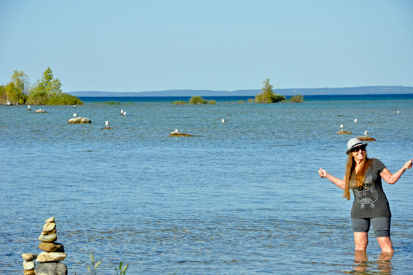 Karen Duquette walks in the water at Grand Traverse Bay